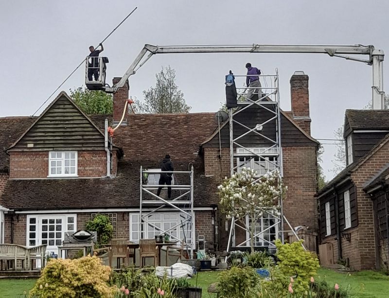 The Roof Moss Cleaners using cherry picker and scaffolding to clean roof safely and professionally in Buntingford, Hertfordshire